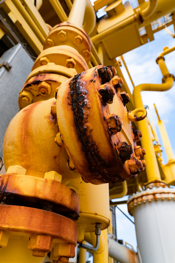 A corroded flange ring on an industrial valve assembly in an offshore application